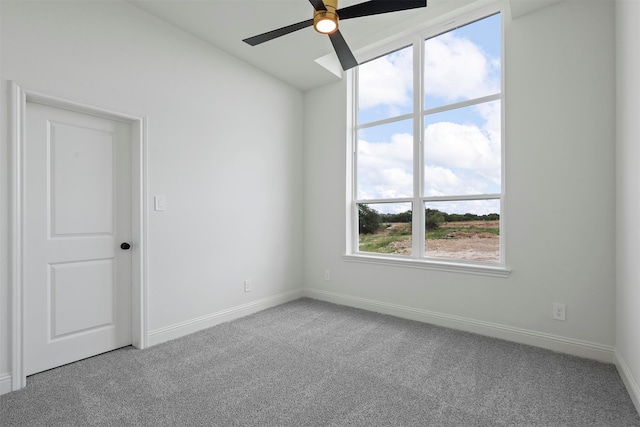 empty room featuring ceiling fan and carpet flooring