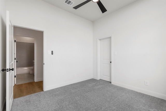 empty room featuring carpet floors and ceiling fan