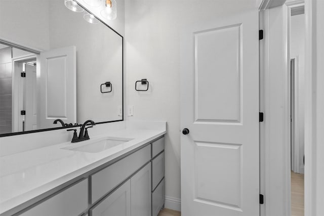 bathroom with hardwood / wood-style floors and vanity