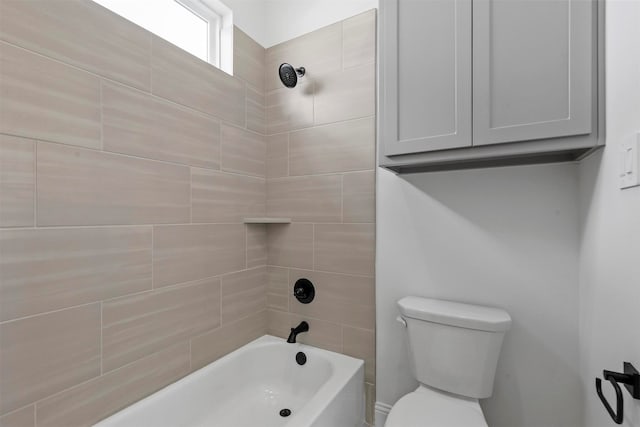 bathroom with toilet and tiled shower / bath combo