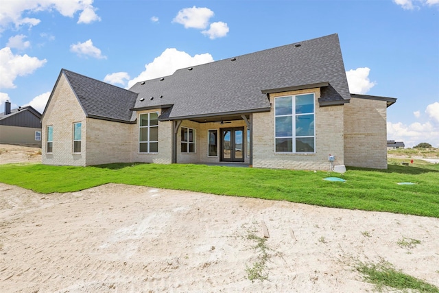 rear view of property with a lawn