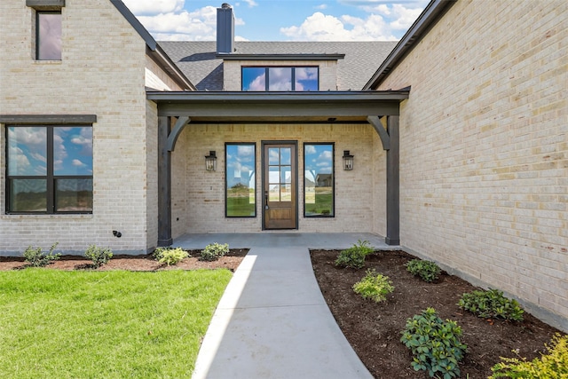 entrance to property featuring a yard