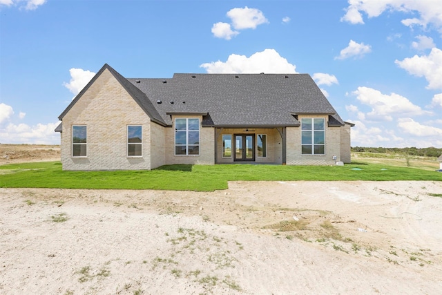 back of house featuring a lawn and french doors