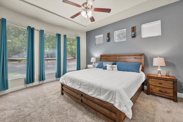 bedroom with ceiling fan, baseboards, and carpet