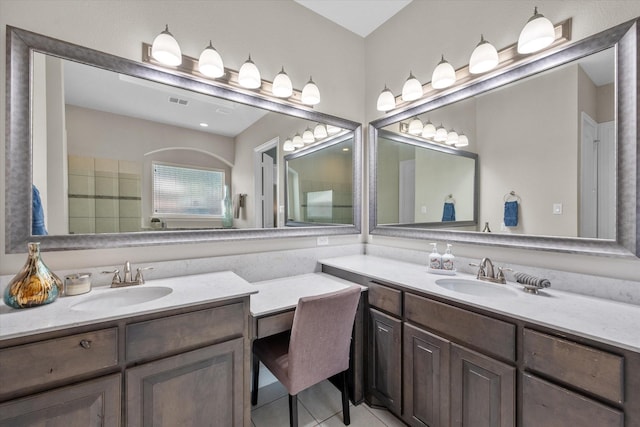 full bathroom featuring tile patterned flooring, two vanities, and a sink