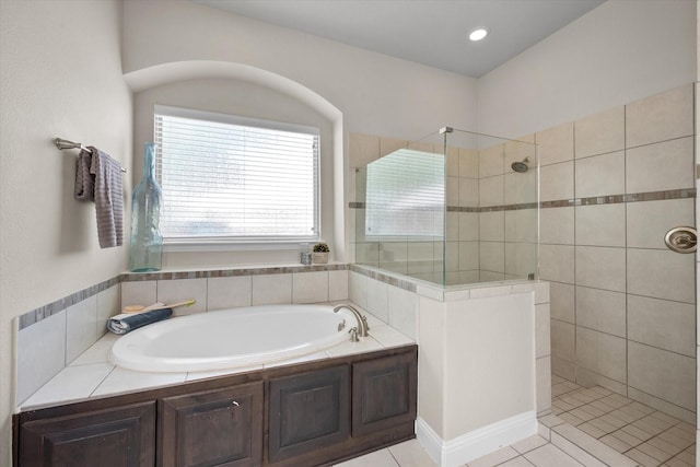 bathroom with tile patterned floors, a garden tub, walk in shower, and recessed lighting