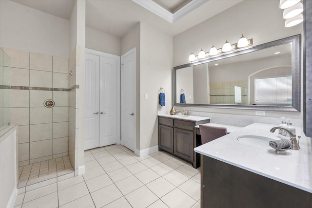 bathroom with crown molding, a walk in shower, two vanities, and a sink