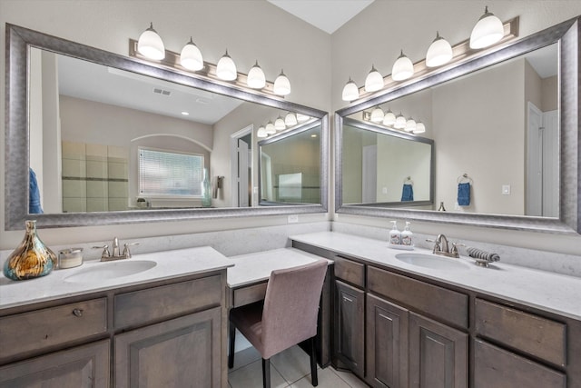 bathroom featuring two vanities, tile patterned flooring, and a sink