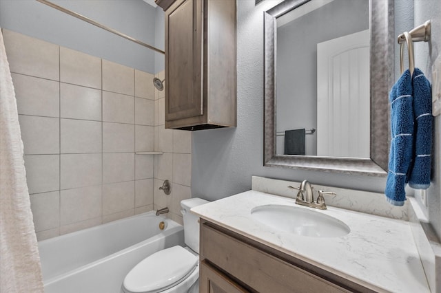 full bathroom with toilet, shower / bath combo, vanity, and a textured wall