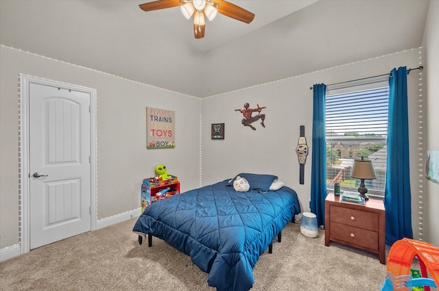 bedroom featuring vaulted ceiling, carpet, baseboards, and ceiling fan