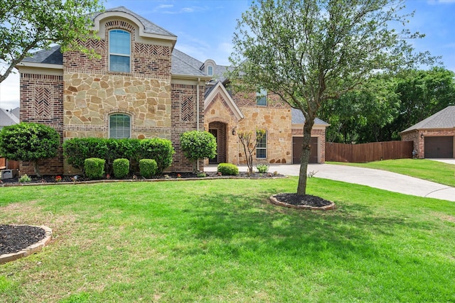 view of front of home featuring concrete driveway, stone siding, an attached garage, and fence