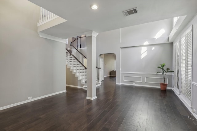 unfurnished living room with dark hardwood / wood-style flooring