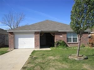 ranch-style home featuring a front lawn and a garage