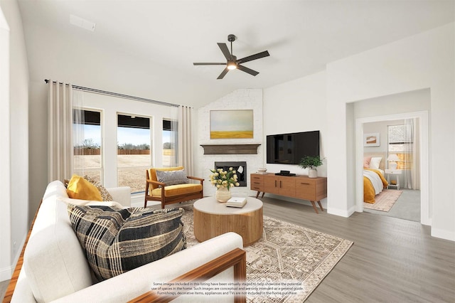 living room with baseboards, a ceiling fan, lofted ceiling, light wood-type flooring, and a fireplace