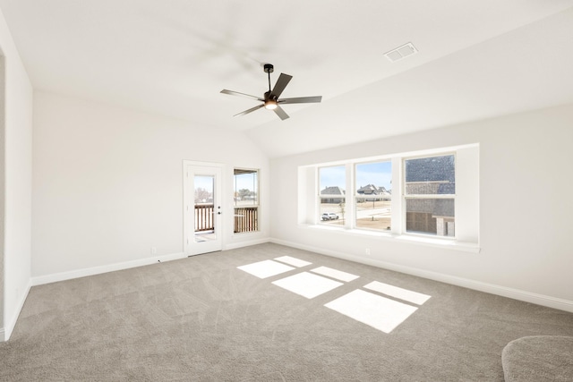 spare room with lofted ceiling, light colored carpet, and ceiling fan