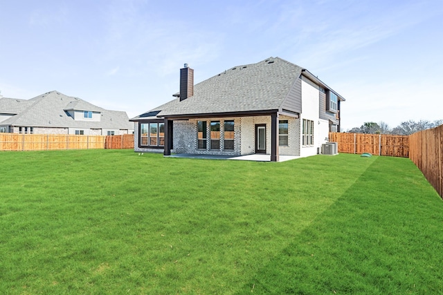 back of house with a patio, a yard, and central AC unit