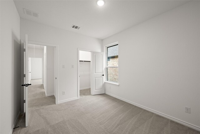 unfurnished bedroom with light carpet