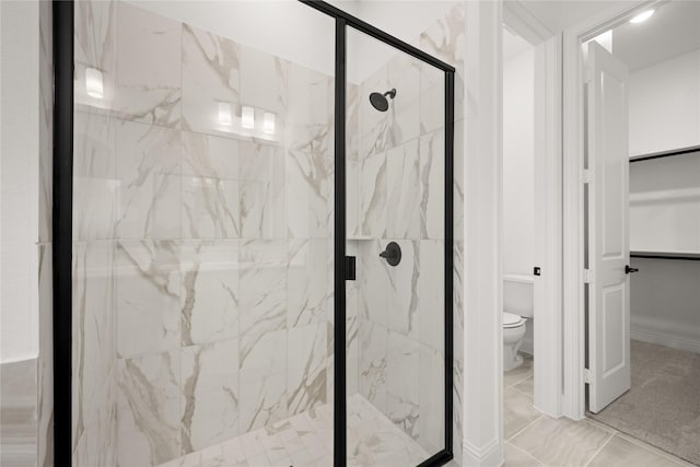 bathroom featuring toilet and an enclosed shower