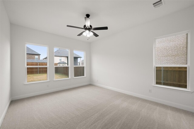 unfurnished room featuring light carpet and ceiling fan