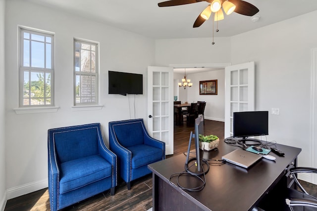 home office featuring ceiling fan with notable chandelier and dark hardwood / wood-style flooring