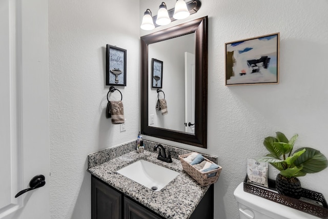 bathroom with toilet and vanity