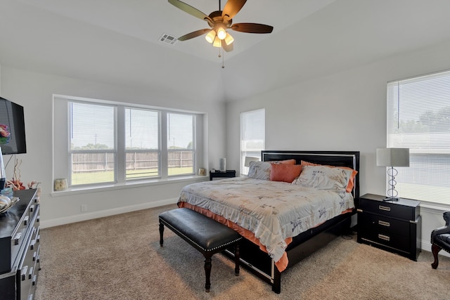 bedroom with light colored carpet, vaulted ceiling, and ceiling fan