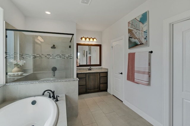 bathroom with separate shower and tub, vanity, and tile patterned floors