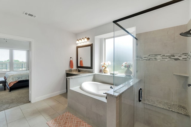 bathroom featuring plus walk in shower, tile patterned floors, and vanity