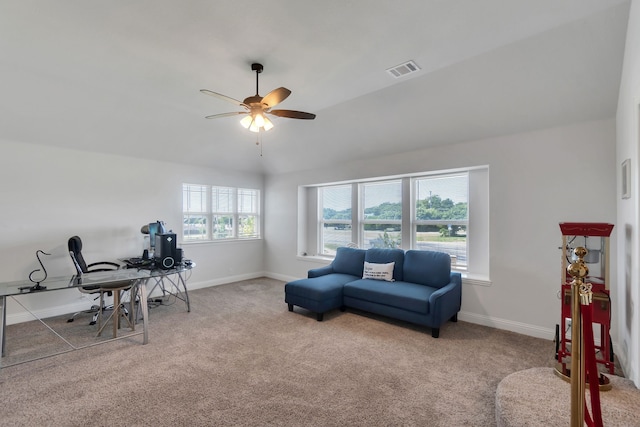 carpeted home office featuring ceiling fan