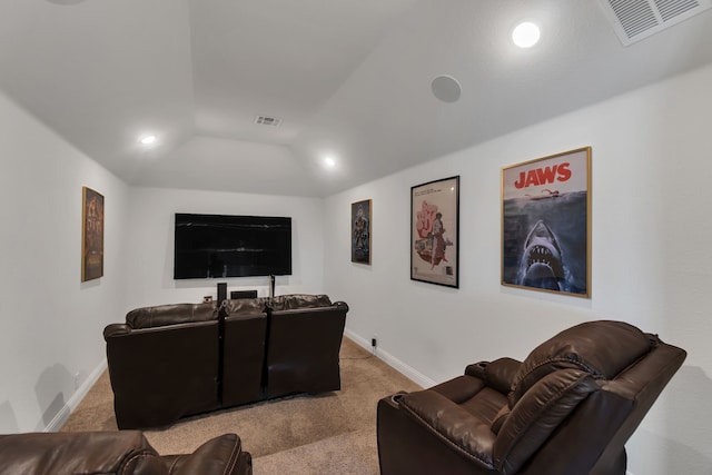 carpeted cinema room featuring vaulted ceiling