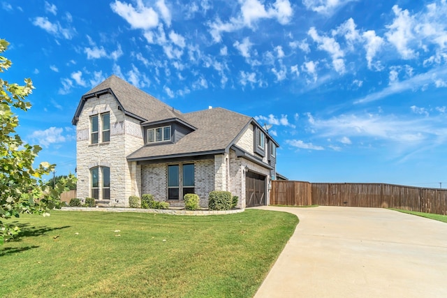 view of front of property featuring a front lawn and a garage