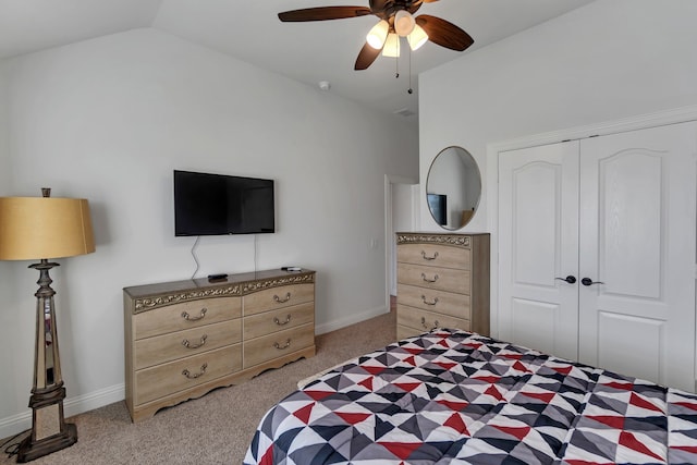 carpeted bedroom featuring ceiling fan, vaulted ceiling, and a closet