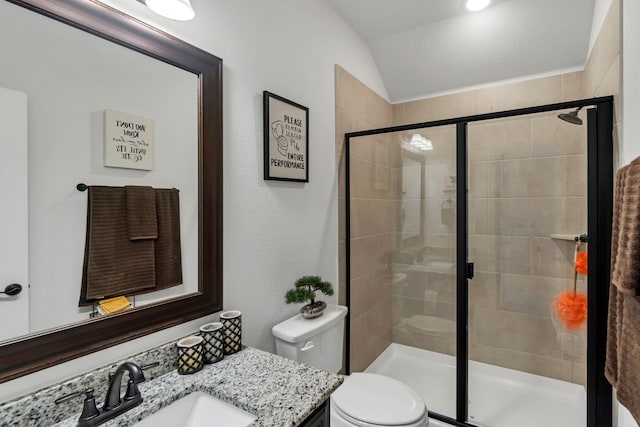 bathroom with vaulted ceiling, toilet, an enclosed shower, and vanity