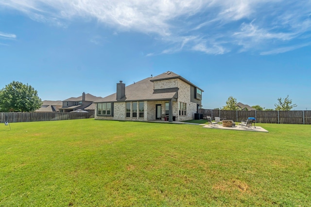 rear view of house featuring an outdoor fire pit, central AC, a patio area, and a yard