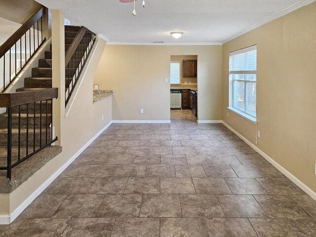 spare room with a textured ceiling, crown molding, and dark tile patterned flooring