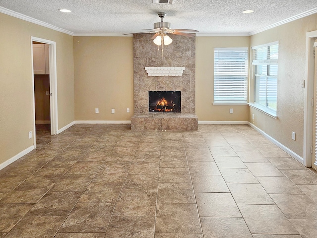 unfurnished living room with a textured ceiling, ceiling fan, a tiled fireplace, and tile patterned floors