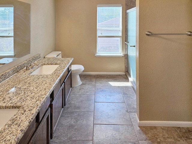 bathroom featuring tile patterned flooring, toilet, and vanity