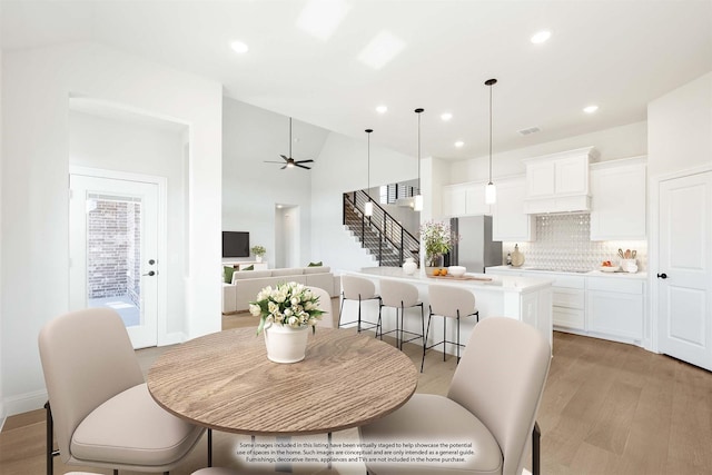 dining room featuring recessed lighting, visible vents, a ceiling fan, stairway, and light wood finished floors