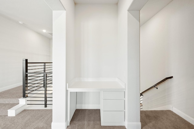 interior space featuring carpet floors and baseboards