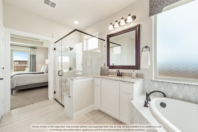 bathroom featuring independent shower and bath, vanity, and tile patterned floors