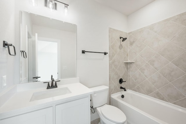 bathroom with washtub / shower combination, vanity, and toilet