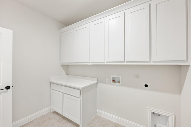 laundry room with hookup for a washing machine, cabinet space, hookup for an electric dryer, gas dryer hookup, and baseboards