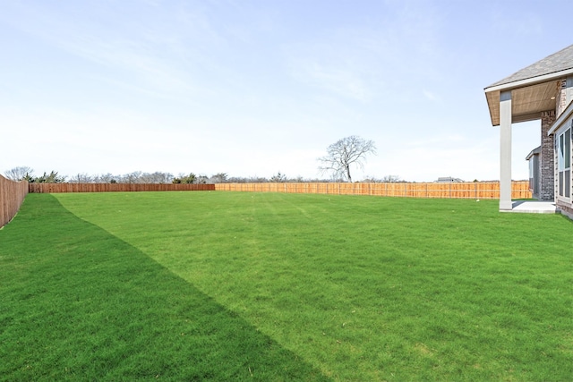 view of yard with a fenced backyard