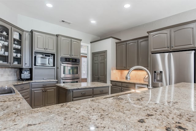 dining area featuring a tiled fireplace, ceiling fan, built in features, and ornamental molding