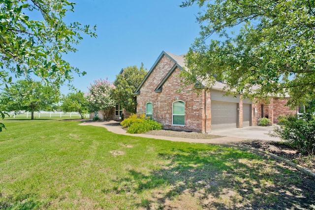 view of front of property featuring a front yard and a garage