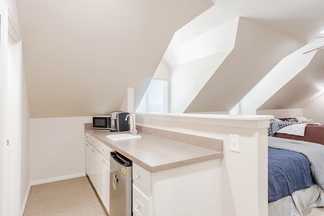 bedroom featuring ceiling fan, light carpet, and vaulted ceiling