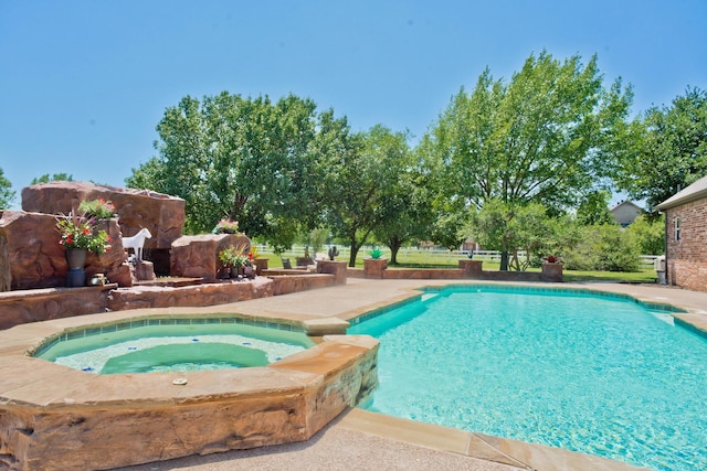 view of swimming pool with an in ground hot tub