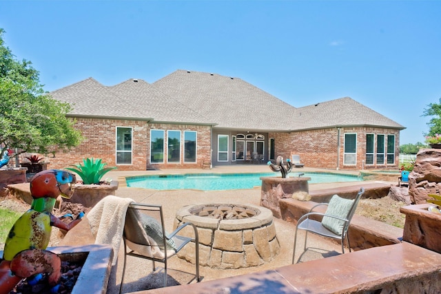 view of pool with a fire pit and a patio area