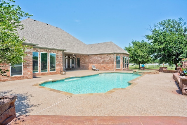 view of pool featuring an in ground hot tub and a patio