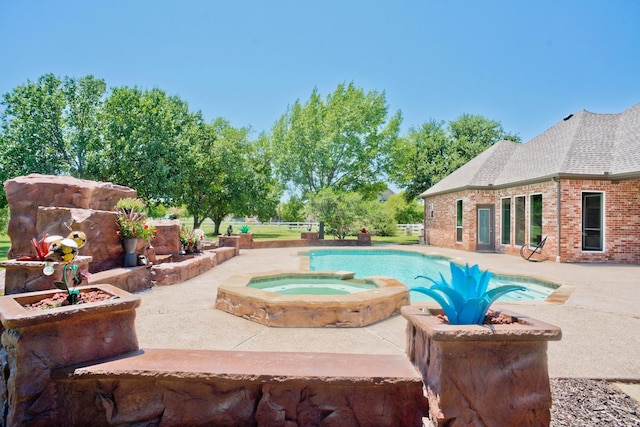 view of swimming pool with an in ground hot tub and a patio